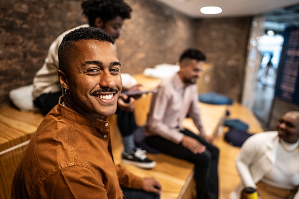 Group of friends smiling and chatting indoors.